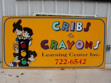 Cribs To Crayons Sign