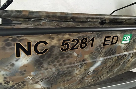 Black and Gold Boat Numbers on Camo Boat